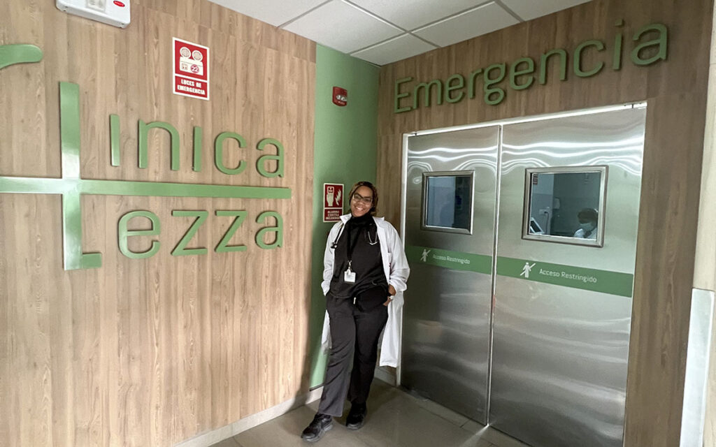 A medical student standing in the threshold of an emergency room.