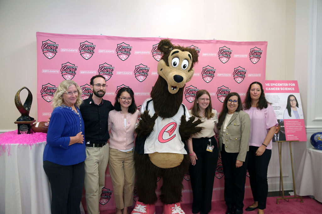 Dr. Annette Khaled, second from right, stands with UCF students and collaborators at the Orlando Sports Foundation's Kickoff to Cure fundraising event.