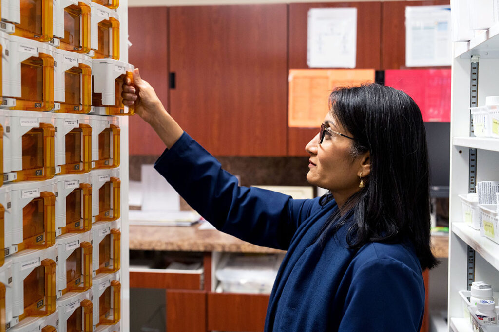 Dr. Binita Patel checks the number of pills in one of Pillbert's 108 cassettes used to store medication. 