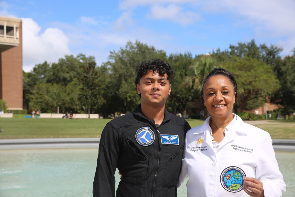 Dr. Melanie Coathup and aerospace engineering student Achintya Bairat display the student-designed patch.
