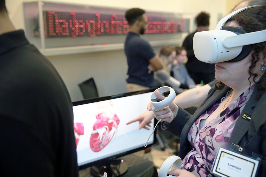 A Senior Design Showcase attendee examines a heart in virtual reality. 