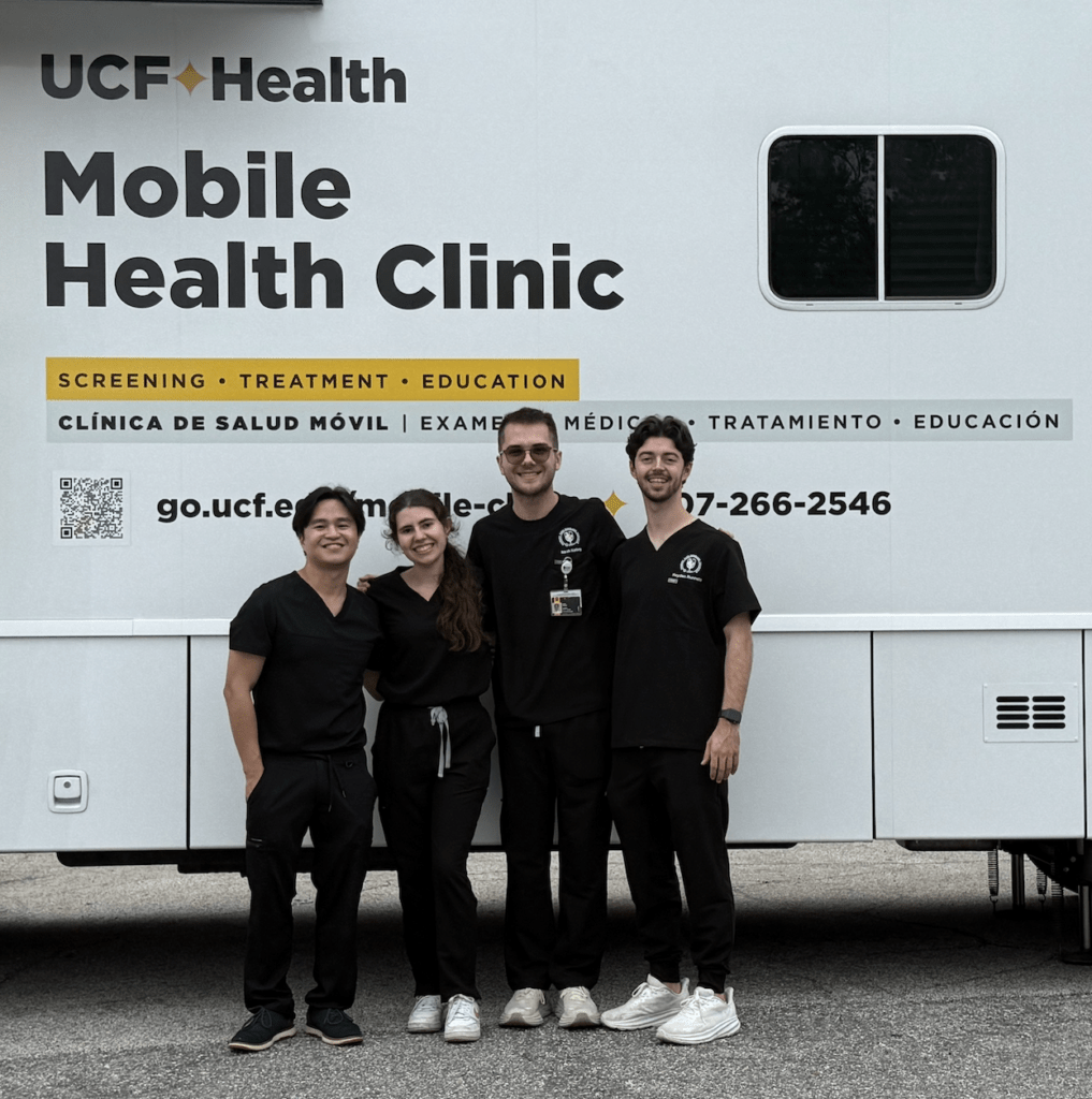 PCP Scholars in front of UCF Mobile Clinic RV. 