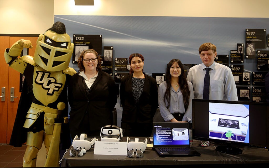 Senior computer science students pose with their clinical imaging app project and Knightro at the College of Engineering and Computer Science  Fall 2025 Senior Design Showcase. 