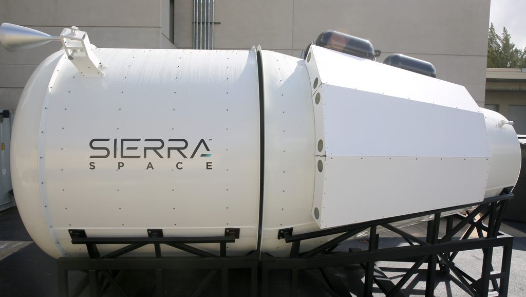 A full sized space capsule mock up outside. 